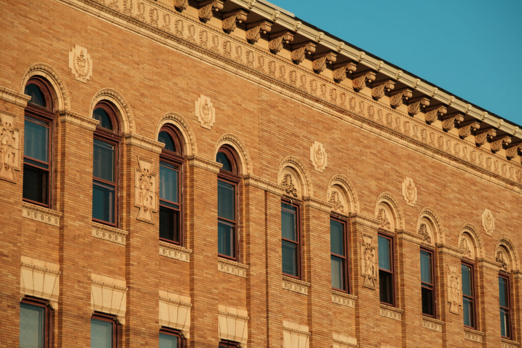 Architectural details on the bank building in Flemington. Orange brick building with rounded top windows.