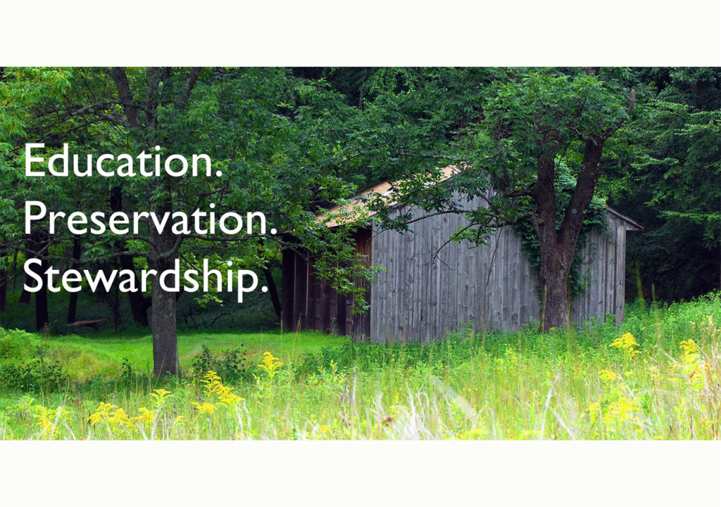 Wood pole barn in a wooded clearing with the words Education. Preservation. and Stewardship over the image.