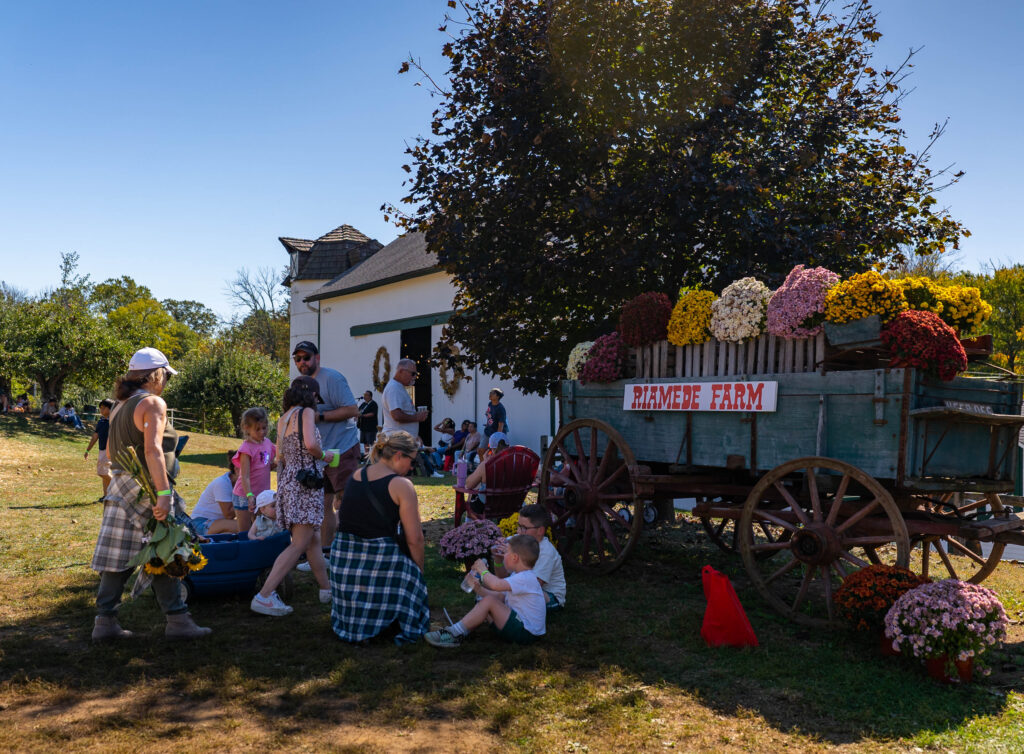 families gathered in front of flower-filled carriage at Riamede Farms